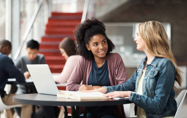 istock Diversity, laptop and tech students conversation together at campus. University, women colleagues working and reading education notes or online technology web design collaboration communication 1438181337
