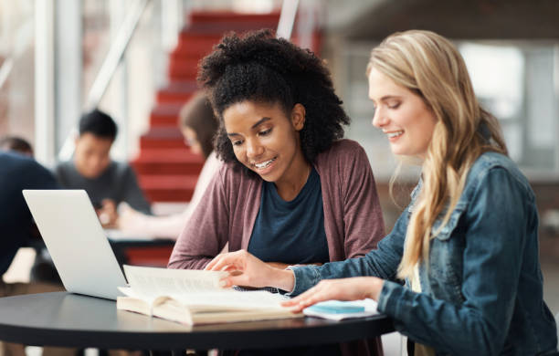 istock Education study, laptop or learning students planning for test, exam or research project on school campus. University, college friends or relax diversity for teamwork, study or scholarship review 1438181346