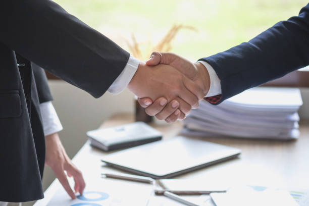 istock two business men shake hands for business cooperation 1438181384