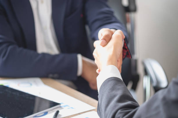 istock two business men shake hands for business cooperation 1438181462