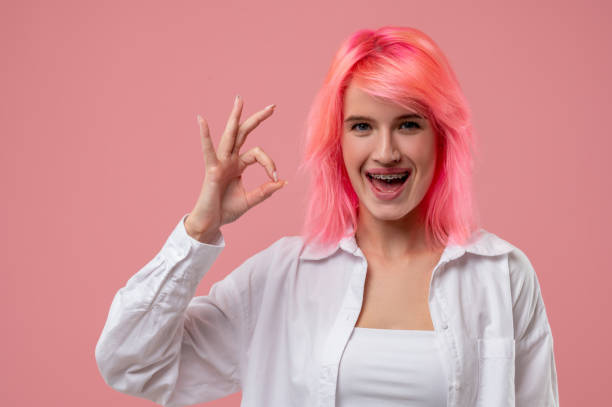 istock Smiling pleased young woman showing a ring gesture 1438182034
