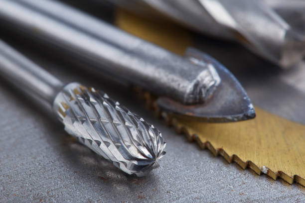 istock set of different drill bits,thread tap and mill cutters with caliper ruler on steel plate background. Locksmithing deal. 1438182885