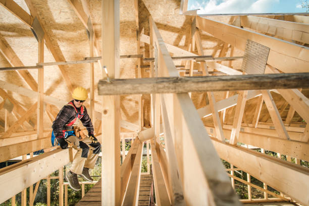 istock Construction Worker Sitting on a Wooden Roof Beam 1438182994