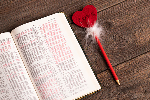 Bible and pencil with heart