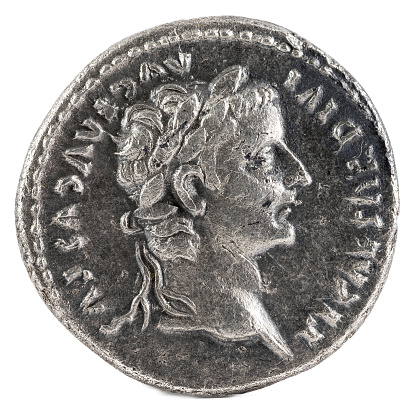 An ancient Roman silver denarius coin of Emperor Tiberius. Obverse.