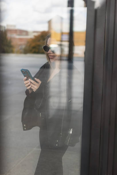 istock Beautiful young woman using smartphone 1438184053