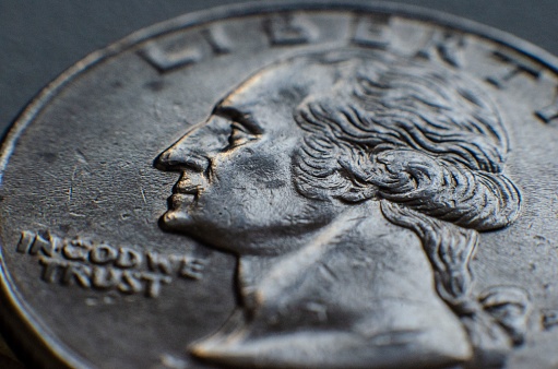 A closeup shot of silver liberty coin isolated on a gray background