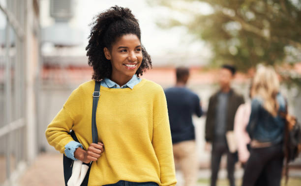 istock Student, education and learning with a black woman on university or campus walking to class to study for a qualification. Academic, college and growth with a female pupil taking a walk outdoor 1438184692