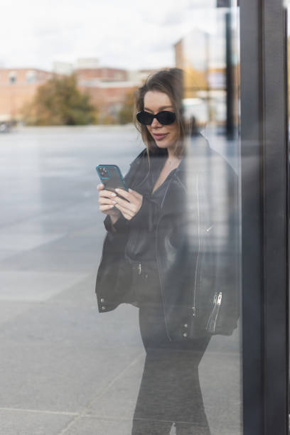 istock Beautiful young woman using smartphone 1438185105