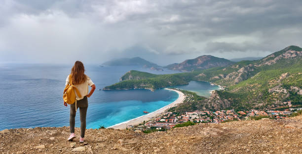 Hiker girl on the mountain top. Sport and active life concept. Oludeniz, Turkey. stock photo