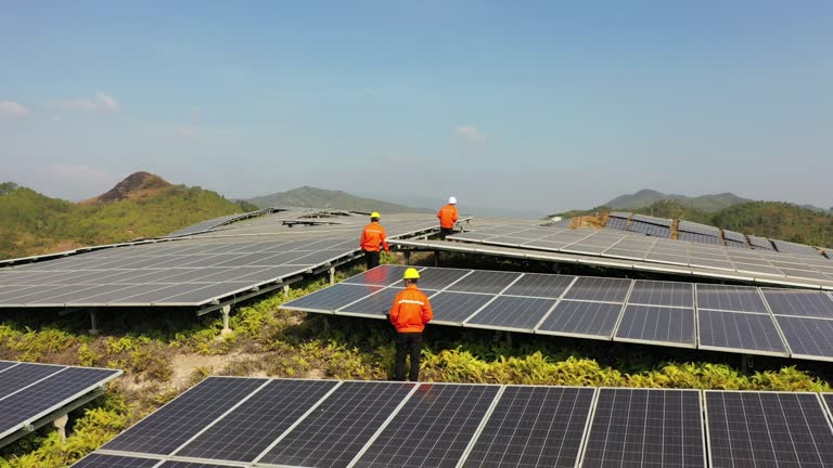 Three technicians inspecting solar panels while walking