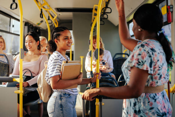 istock Black woman and student talking on city bus 1438188541
