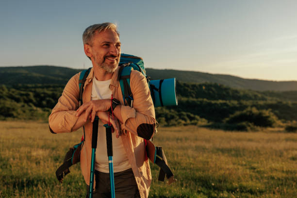 istock Male with backpack walking with the help of hiking poles 1438189175
