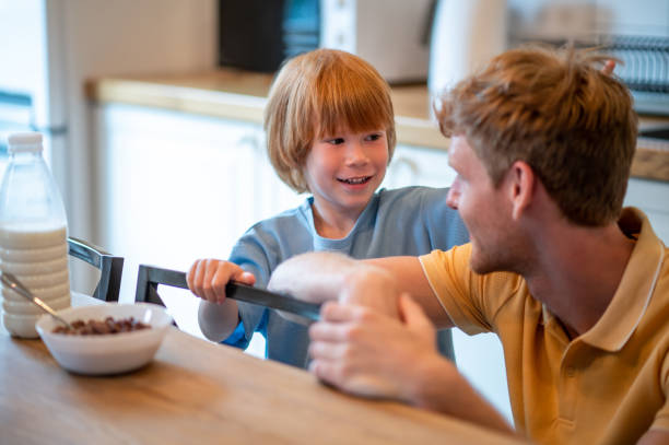 istock Ginger man and his son spending time together and looking involved 1438189426