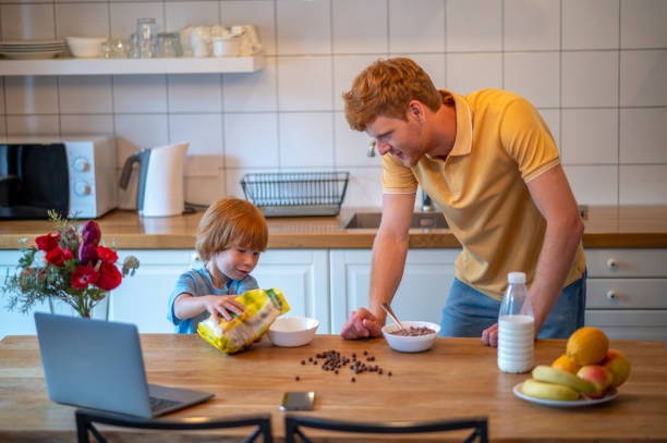 istock Ginger man and his son spending time together and looking involved 1438189431