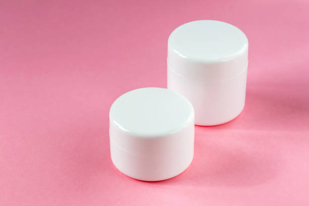 istock Two cosmetic jars on a pink background 1438189577