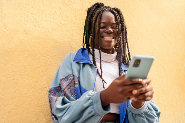 istock Happy African Woman Using Phone 1438190226