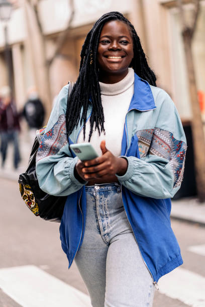 istock Happy African Girl Using Phone 1438190383