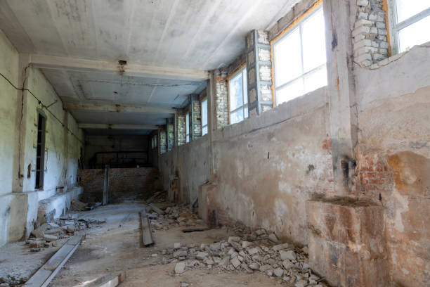 istock Broken floor, trash and clutter in an abandoned room 1438193095