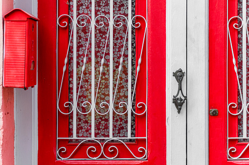 Door of a house with windows, painted bright red