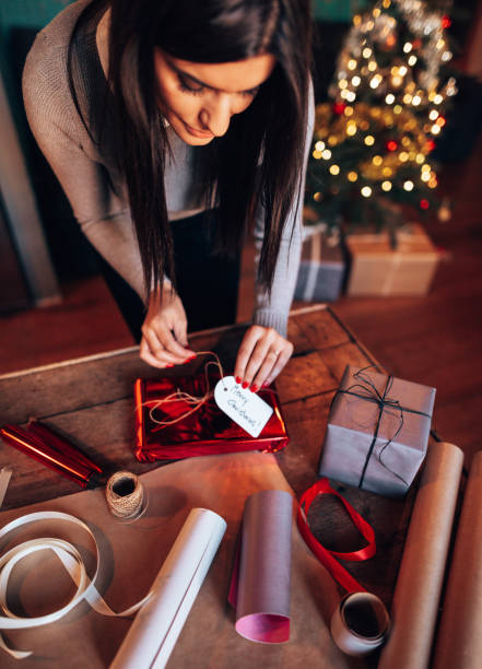 istock woman making the package for the christmas gift 1438193413