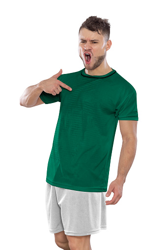 Professional soccer player with a Saudi Arabia national team jersey shouting with excitement for scoring a goal with an expression of challenge and happiness on a white background.