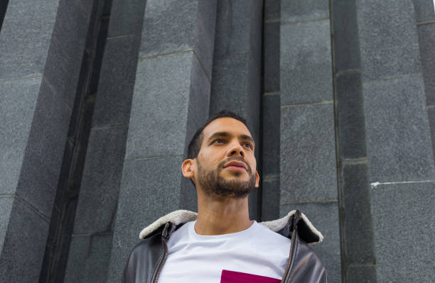 istock low angle headshot of a latin guy looking away ahead a gray marble structure 1438199030