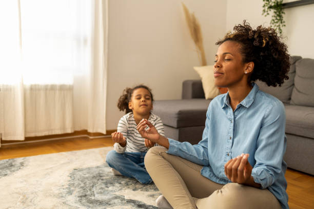 Mother and daughter practice meditation
