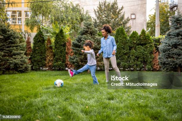 Mother And Daughter Are Playing With A Ball Outdoors Stock Photo - Download Image Now