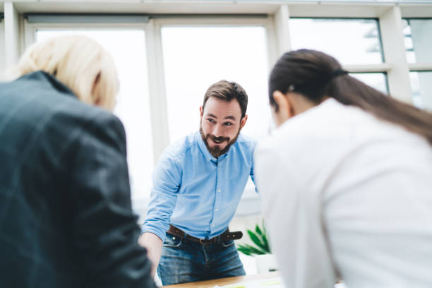 istock Anonymous women and smiling man in office 1438201085
