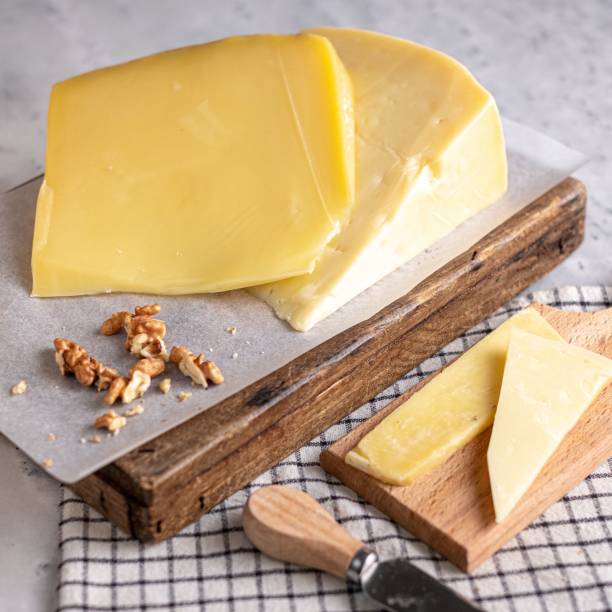 istock Block of cheese on a wooden cutting board 1438202044