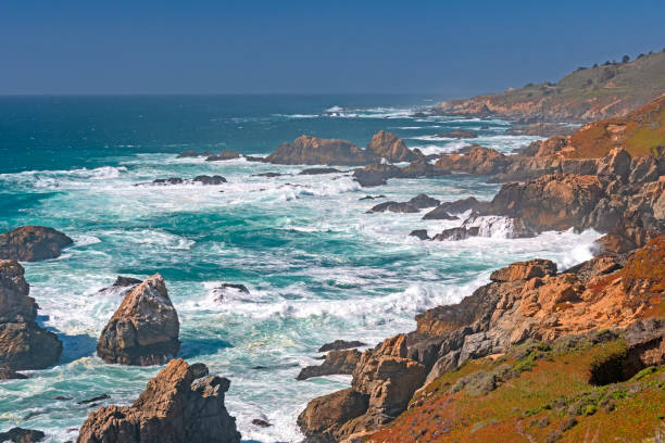 istock Sea Foam Amongst the Rocks on a Hazy Coast 1438202429