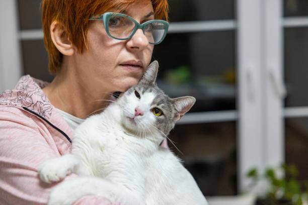 istock Caucasia woman stroking her cat 1438202843