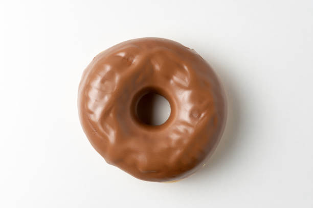 istock Chocolate donut on white background. Top view. 1438203771