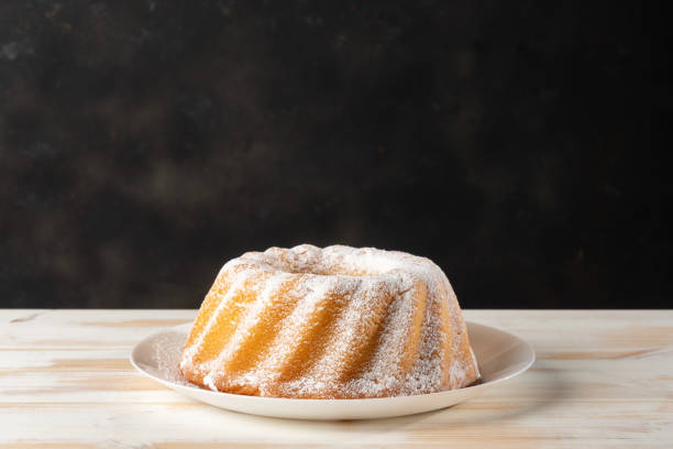 Homemade vanilla bundt cake on white wooden background. Homemade vanilla bundt cake on white wooden background. bunt stock pictures, royalty-free photos & images
