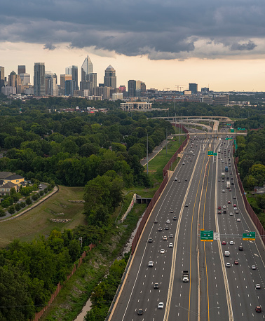 Interstate 77 with the traffic on it in the evening, with a distant view of Downtown in Charlotte, North Carolina, USA, against the stormy sky.