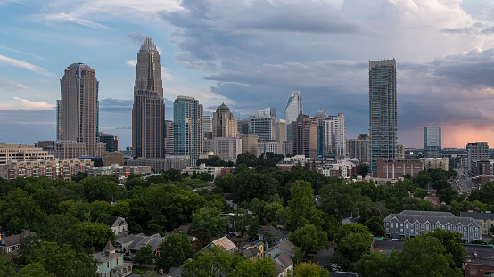 Downtown Charlotte, NC, with luxury apartments against the stormy sky at sunset.