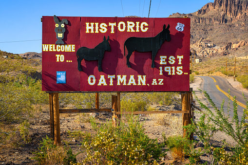 Oatman, Arizona, USA - June 13, 2022 : Entry sign in Oatman village on historic Route 66. This former mining town is situated in the Black Mountains of Mohave County in Arizona.