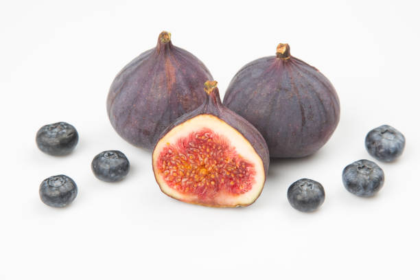 istock fresh figs and blueberries on a white background. Vitamin products 1438207794