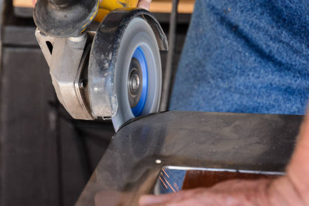 istock Cutting steel with angle grinder at car service 1438207834