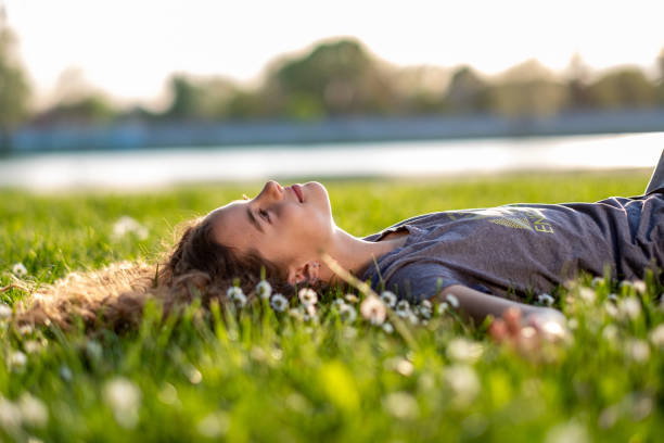 istock the girl is lying on the grass 1438209411