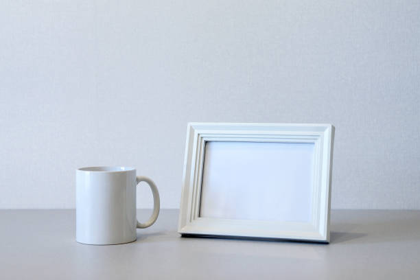 istock Mock up minimalist home interior with white wooden photo frame and ceramic mug 1438209551