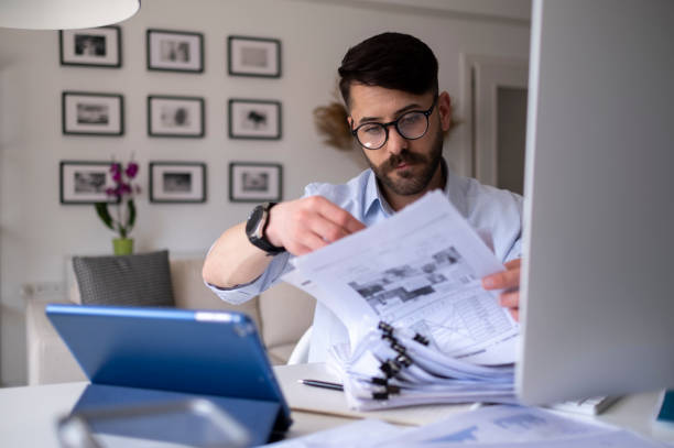 istock Business accounting concept, Business man using calculator with computer laptop, budget and loan paper in office. 1438209794