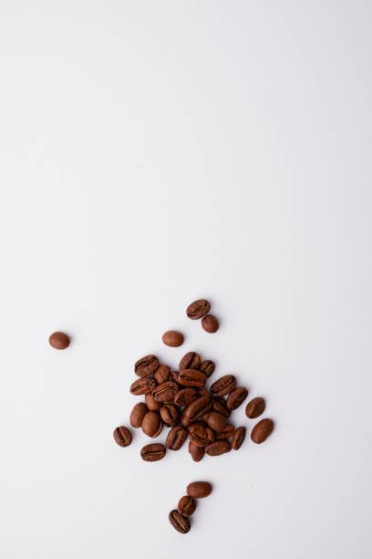 istock Vertical shot of the coffee beans isolated on white background 1438210503