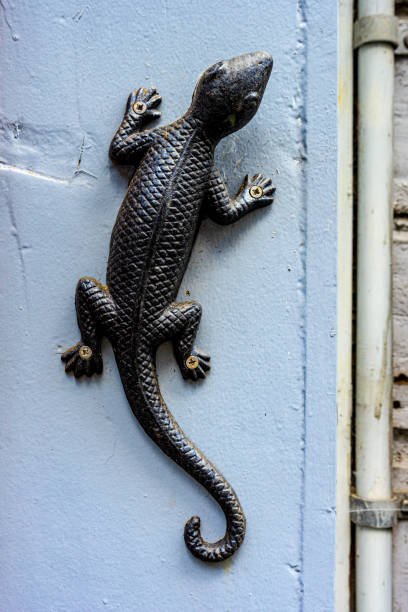 istock Vertical shot of decorative metallic lizard on the wall 1438210505