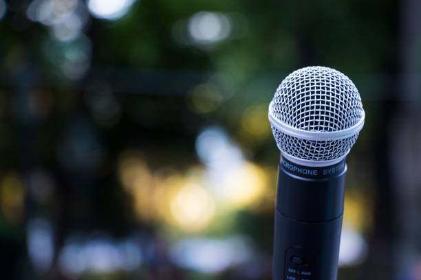 istock Microphone close-up, outdoor background 1438210728