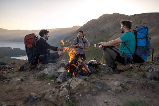 istock Hands of hikers cheering up with camping cups 1438210915