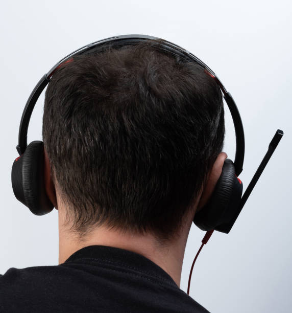 istock Back view of man with headset 1438211399