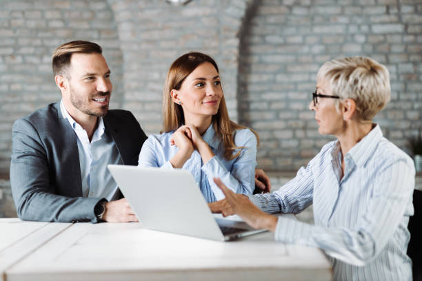 istock Happy couple talking with insurance agent on a meeting 1438212220