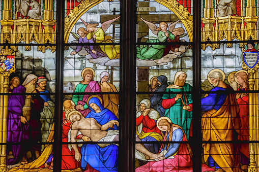 Cologne, Germany – May 19, 2015: Stained glass from Cologne Cathedral (Cathedral Church of Saint Peter) representing the  descent from the cross or deposition of Christ